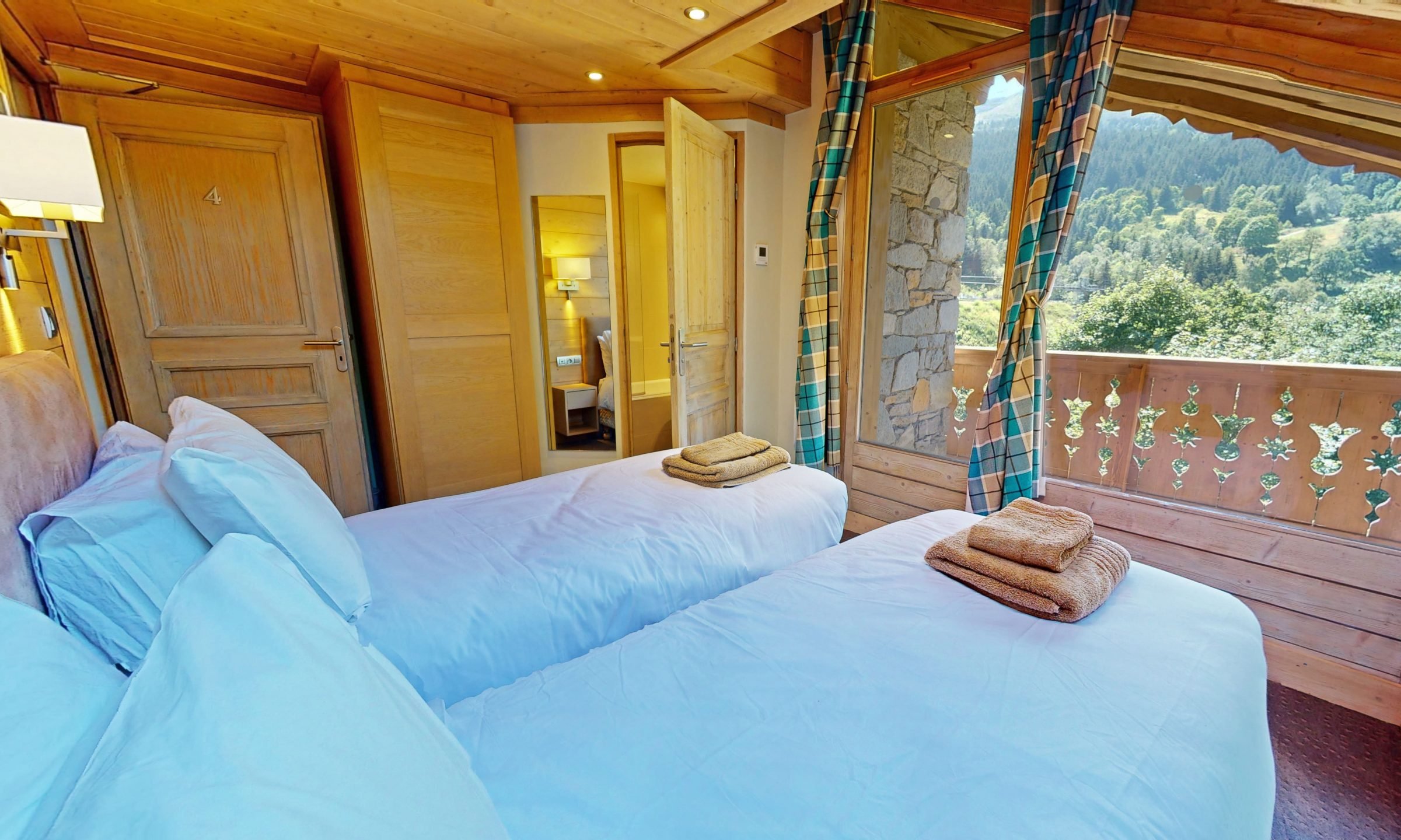 One of the Bedrooms with a balcony in Chalet Eleanor Meribel