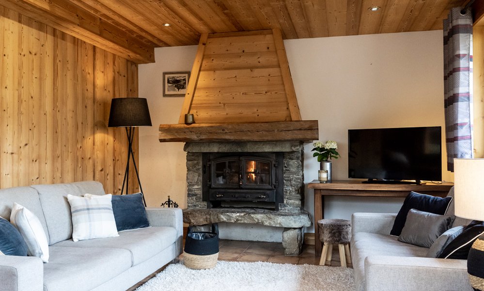 The Living area with a fireplace in Chalet Blanchot Meribel