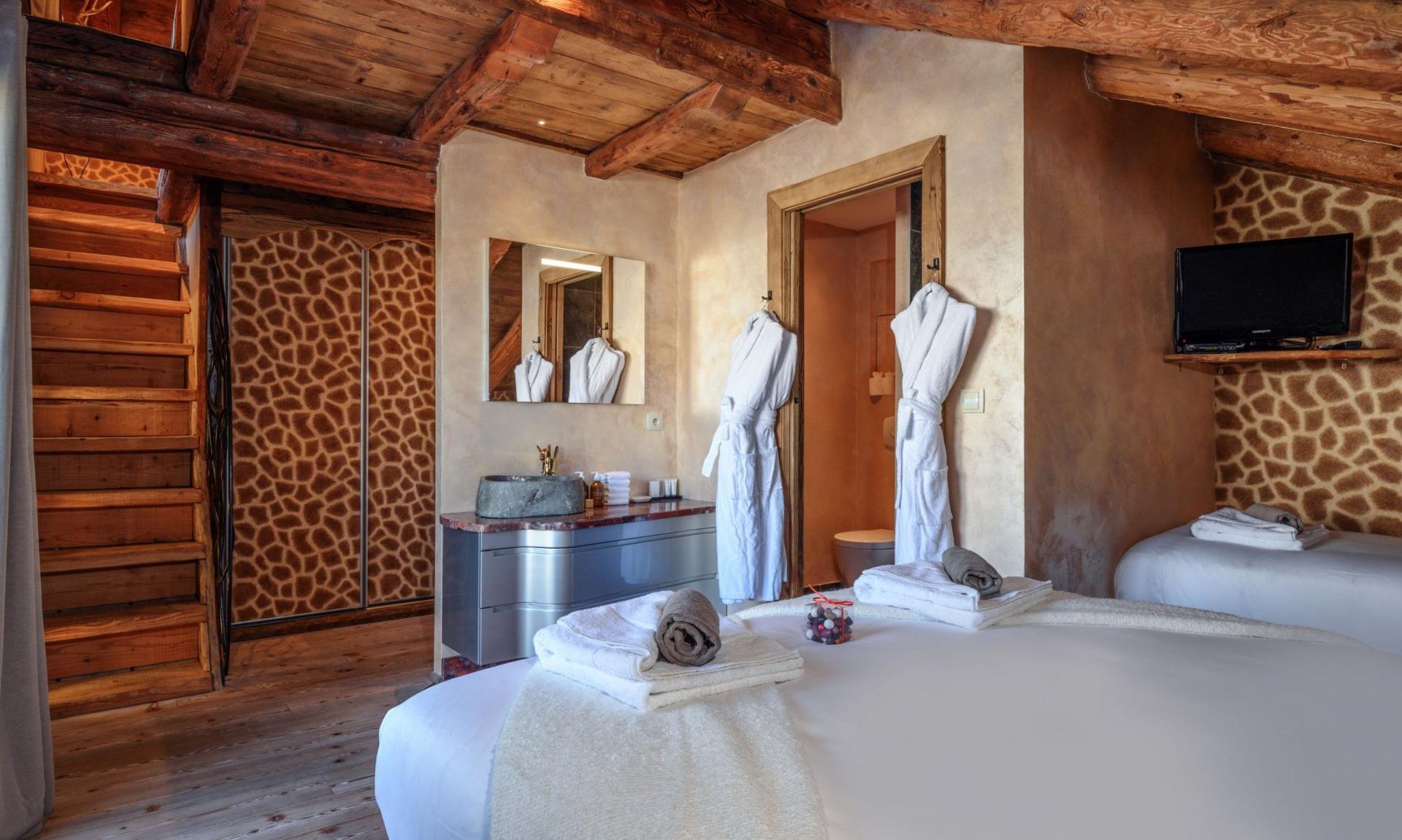 The double bedroom with an extra bed in Catered Chalet Cheval Blanc Meribel Le Raffort