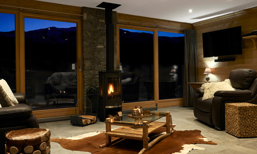 Living room with Stove in Chalet Chamois in Meribel