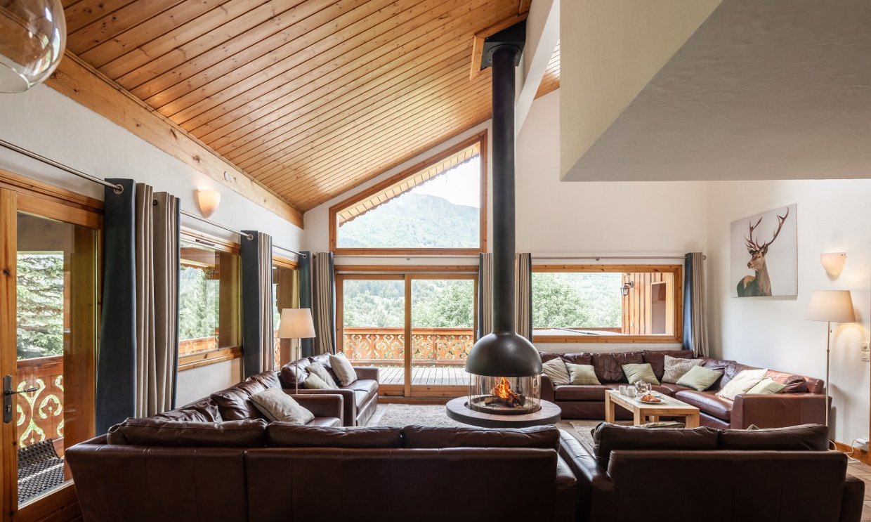 The comfortable Living room with Stove in Chalet Virage Meribel