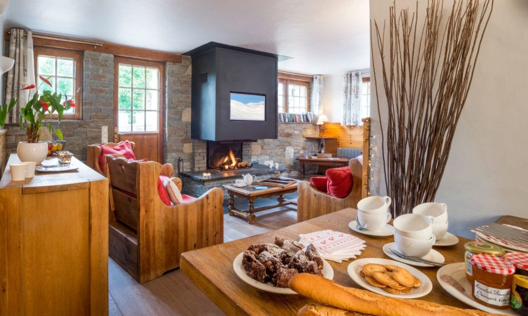 The dining and Living area with fireplace in Chalet Chocolat La Tania
