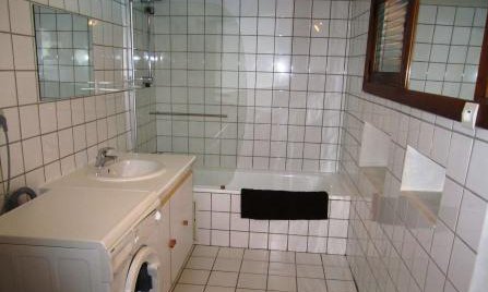 Bathroom with washing machine in Chalet Altitude 1600 in Meribel