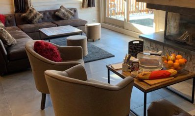 The Living room and fireplace in Chalet Chardon in Meribel