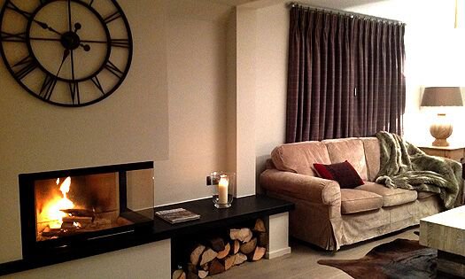 Cosy living room and fireplace in Chalet Montee Meribel