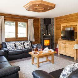 The Living room with stove in Chalet Covie in Meribel Les Allues