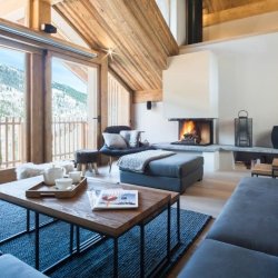 The spacious Living area with a fireplace in Chalet Caro Meribel
