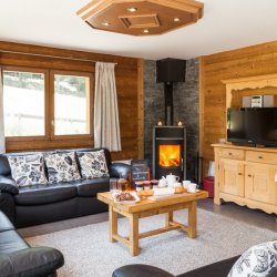 The Living room with stove in Chalet Covie in Meribel Les Allues