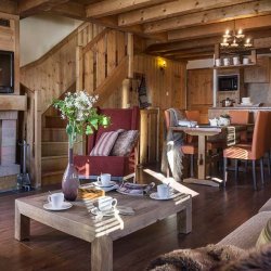 The Living area with fireplace in the 4 Bedroom South facing Apartment in Residence L'Oxalys, Val Thorens