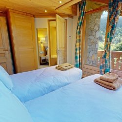 One of the Bedrooms with a balcony in Chalet Eleanor Meribel