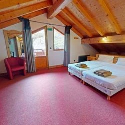 A spacious bedroom in Chalet Daurel, Meribel Centre