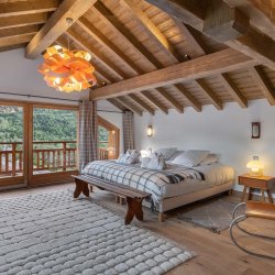 One of the spacious and comfortable bedrooms in Chalet Etoile des Neiges Meribel