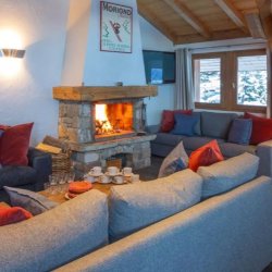 The living area with fireplace in Chalet Rikiki Courchevel Moriond