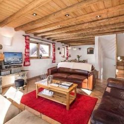 Spacious living room with a fireplace in Chalet Lou Trave Meribel