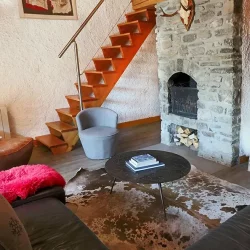 The living room with fireplace in Chalet La Combe Meribel