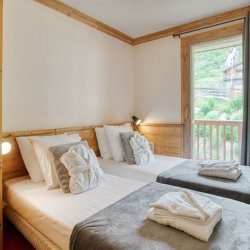 A Twin bedroom in Catered Chalet Petit Sabot in Val Thorens