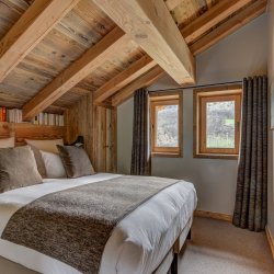 A comfortable bedroom in Chalet Bergeronnette Meribel Nantgerel