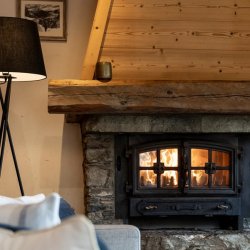 The comfortable living room with fireplace in Chalet Blanchot Meribel