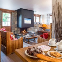 The dining and Living area with fireplace in Chalet Chocolat La Tania