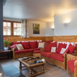 The Living room with a fireplace in Chalet Chocolat La Tania