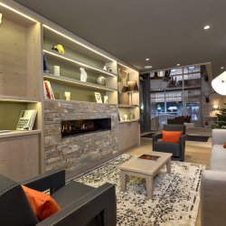 The Lounge area with a fireplace in one of the Apartments in Residence L'Hevana Meribel