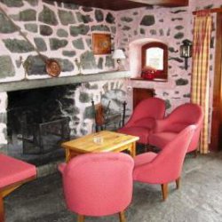 Living area with fireplace in Chalet Altitude 1600 in Meribel