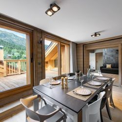 The dining area overlooking the terrace in Apartment Le Glaciers 12 Meribel
